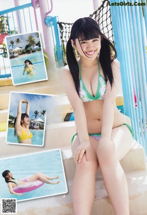 A woman in a pink shirt and blue shorts sitting on a beach.