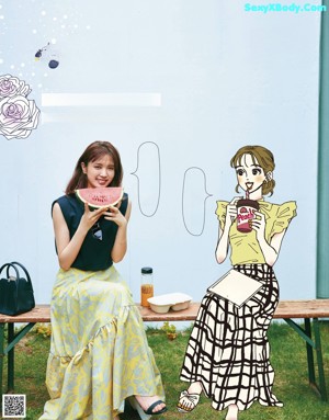 A woman sitting at a table in front of a window.