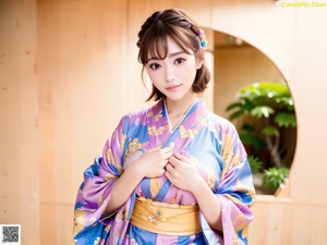 A woman in a blue kimono posing for a picture.
