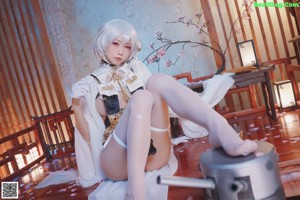 A woman sitting on top of a stool in a room.